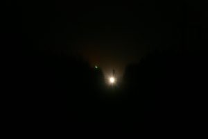 A night picture showing a bright light in the distance, representing the cohoke light