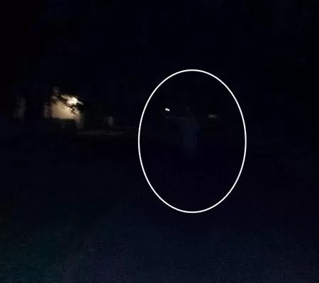 Photo in the dark with mysterious outline of person